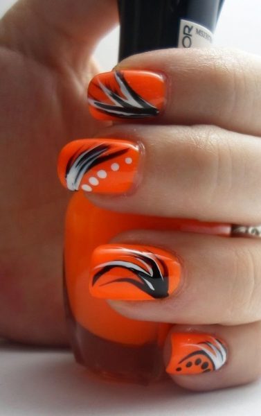 orange nail design with black art