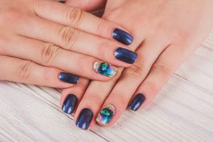 Dark navy square nails, long with peacock feather art, glossy finish, elegant style.