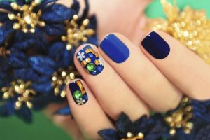 Square shape, medium length, navy and royal blue tones, glossy finish, floral and gem embellishments, sophisticated and decorative style.