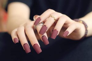 Almond-shaped, long matte mauve nails with minimalistic design.