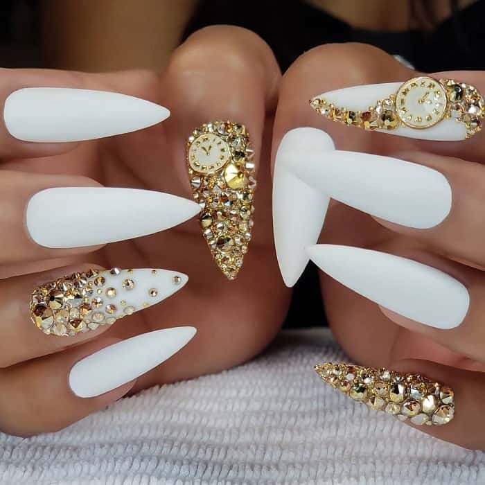 black and white nails with gold rhinestones