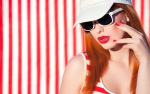 Long square-shaped nails with red and white polish.