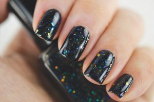 Black base with holographic glitter and star accents.
