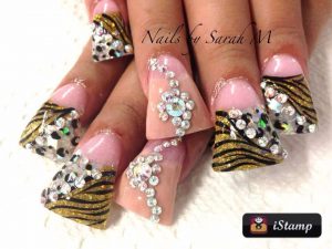 Glamorous square nails with rhinestones, glitter, and zebra design.