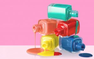 Vivid nail polish bottles in various bright colors with glossy finish and casual style.