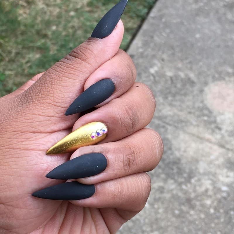 matte black and gold stiletto nails