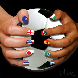 Short oval nails with vibrant national flag designs, matte finish, patriotic style.