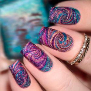 Colorful swirling glitter design, oval shape, medium length, vibrant color palette, textured finish, artistic and whimsical style.
