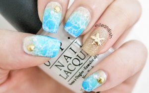 Nail art with shell accents.