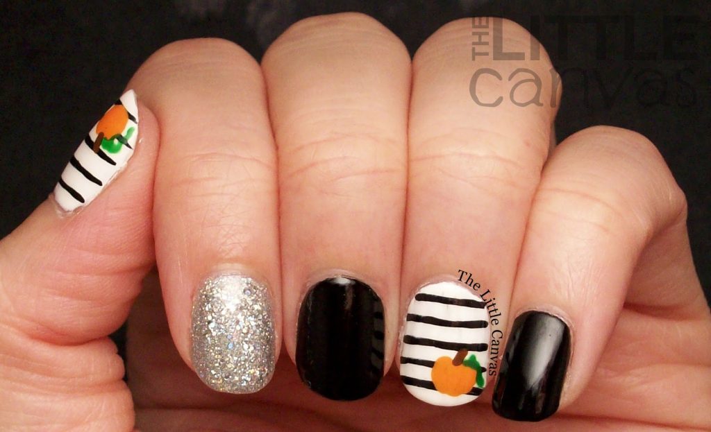 black and white pumpkin nails