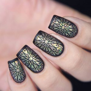 Detailed black and holographic stained glass nail art with oval shape.