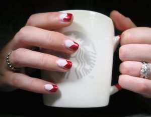 Red and white color palette, glossy finish, oval shape, medium length, French tip design.