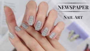 Short square nails with newspaper print design.