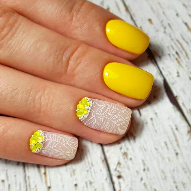 Yellow nail design with rhinestone 