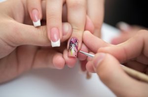 Short square nails, light pink and white, glossy finish, floral nail art, sophisticated style.