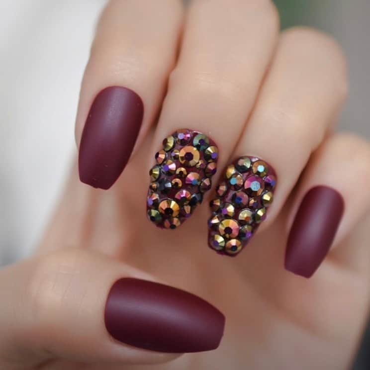 matte maroon nails with rhinestones