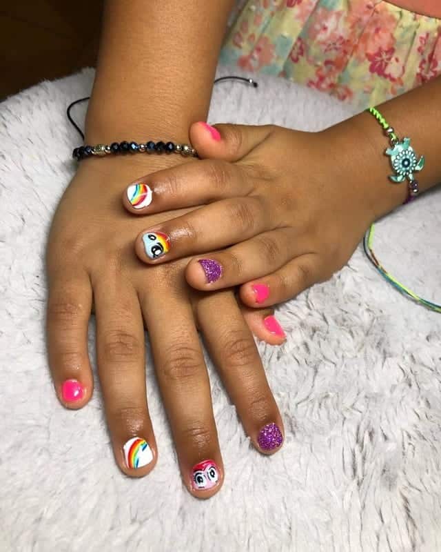 little girl with rainbow nails 