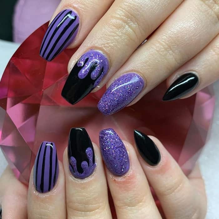 black and purple nails with glitter 