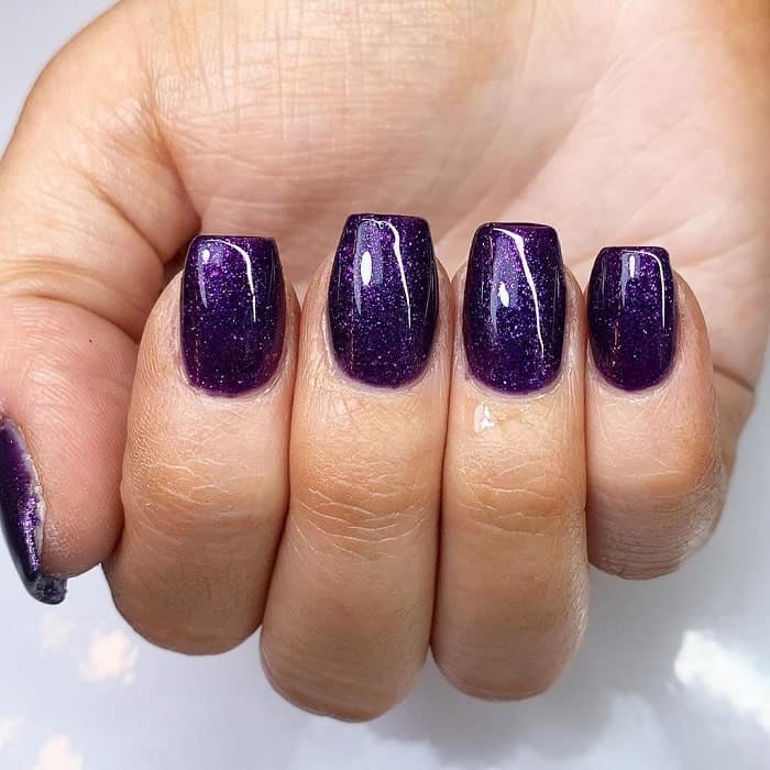 dark purple nails with glitter