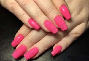 Glossy and matte pink finish, textured accent nails.