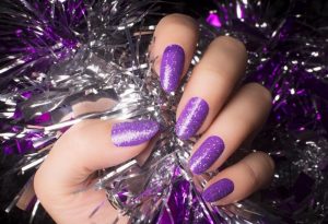 Purple, glitter finish, medium length, almond shape.