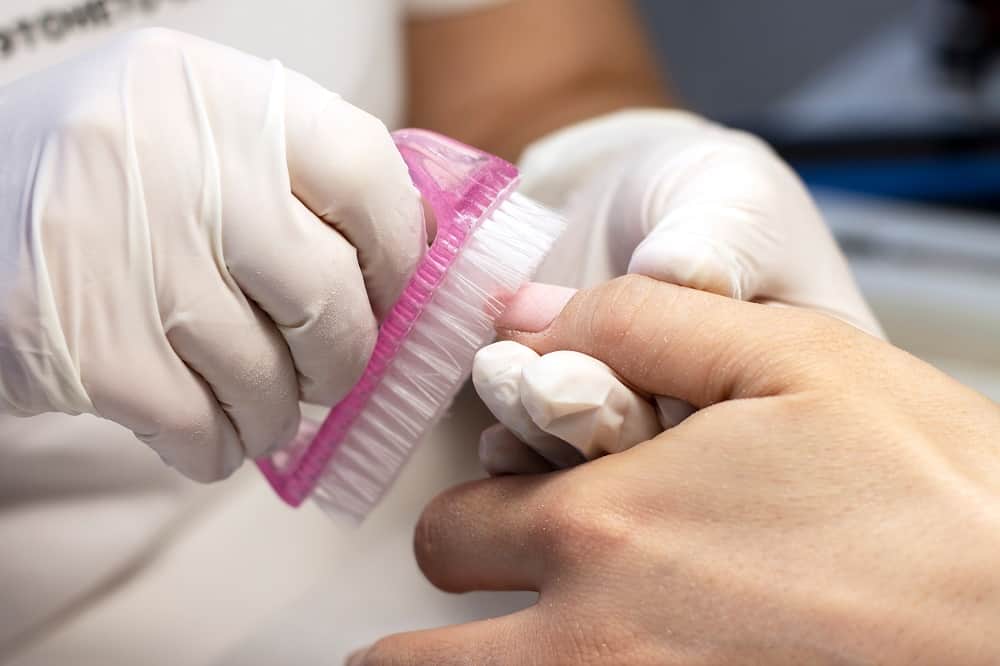 How Nail Technician Fix Cracked Acrylic Nail - Dusting away the residue