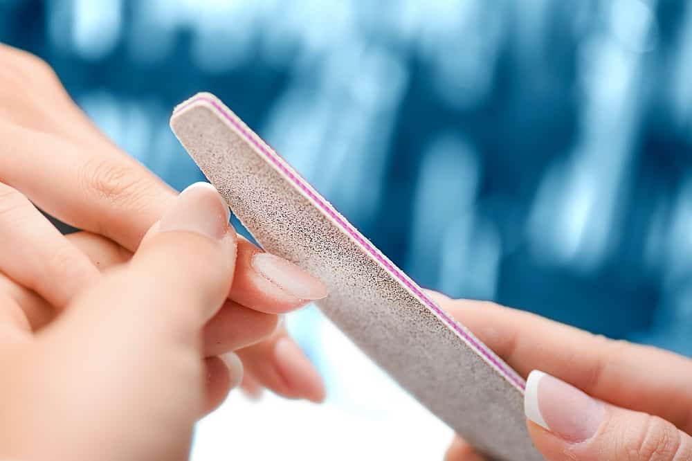 How Nail Technician Fix Cracked Acrylic Nail - filing the crack’s area