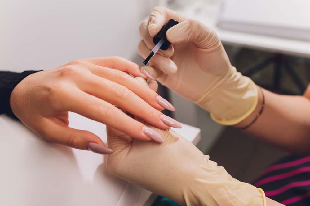 applying gel polish over dip powder nails