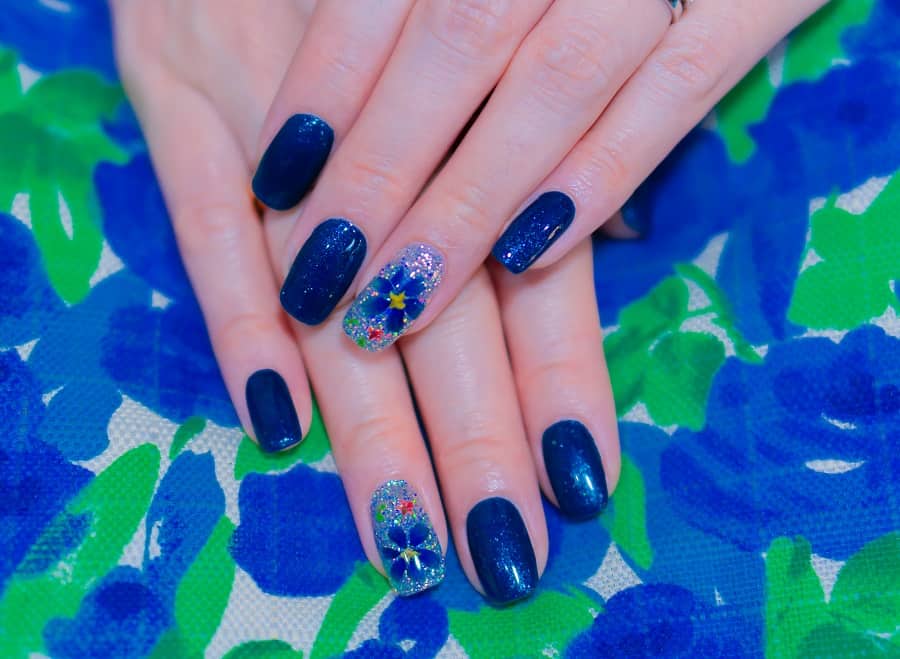 navy blue nail design with flower