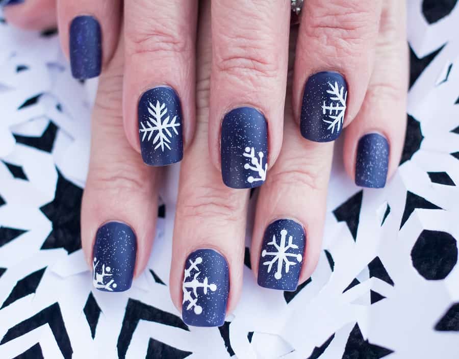 navy blue snow flake nail design