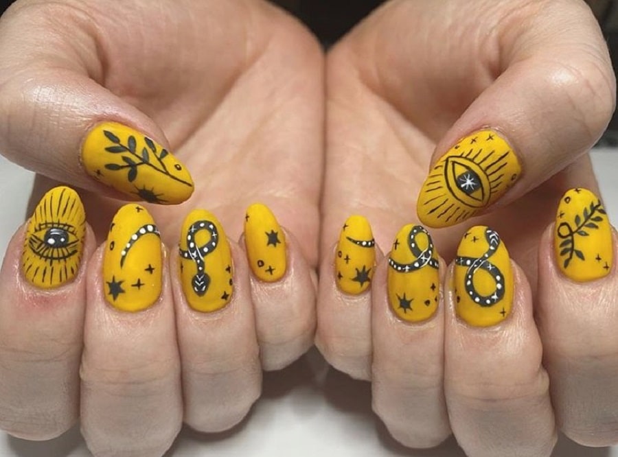 matte mustard nails with tribal design