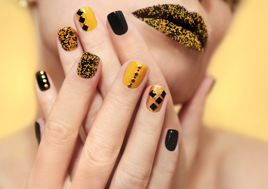 mustard yellow nails with rhinestones