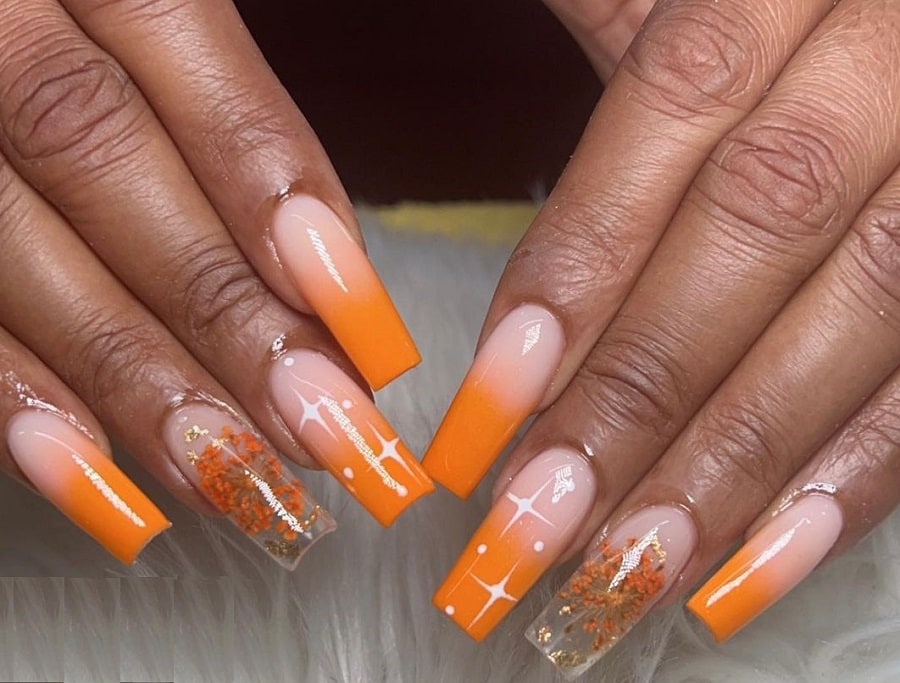 orange ombre nails on dark skin