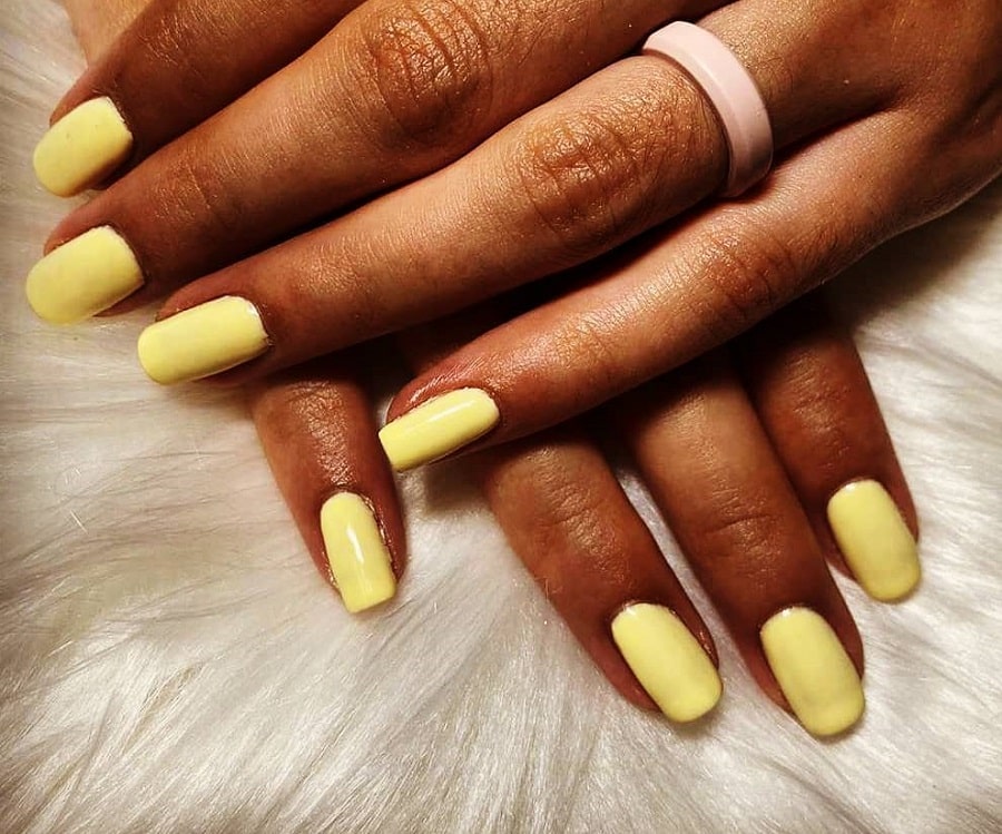 pastel yellow nails on dark skin