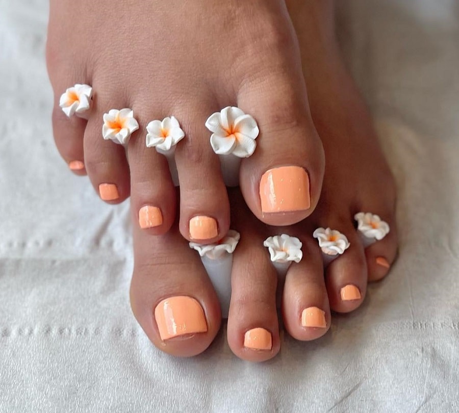 peach color toe nails on dark skin