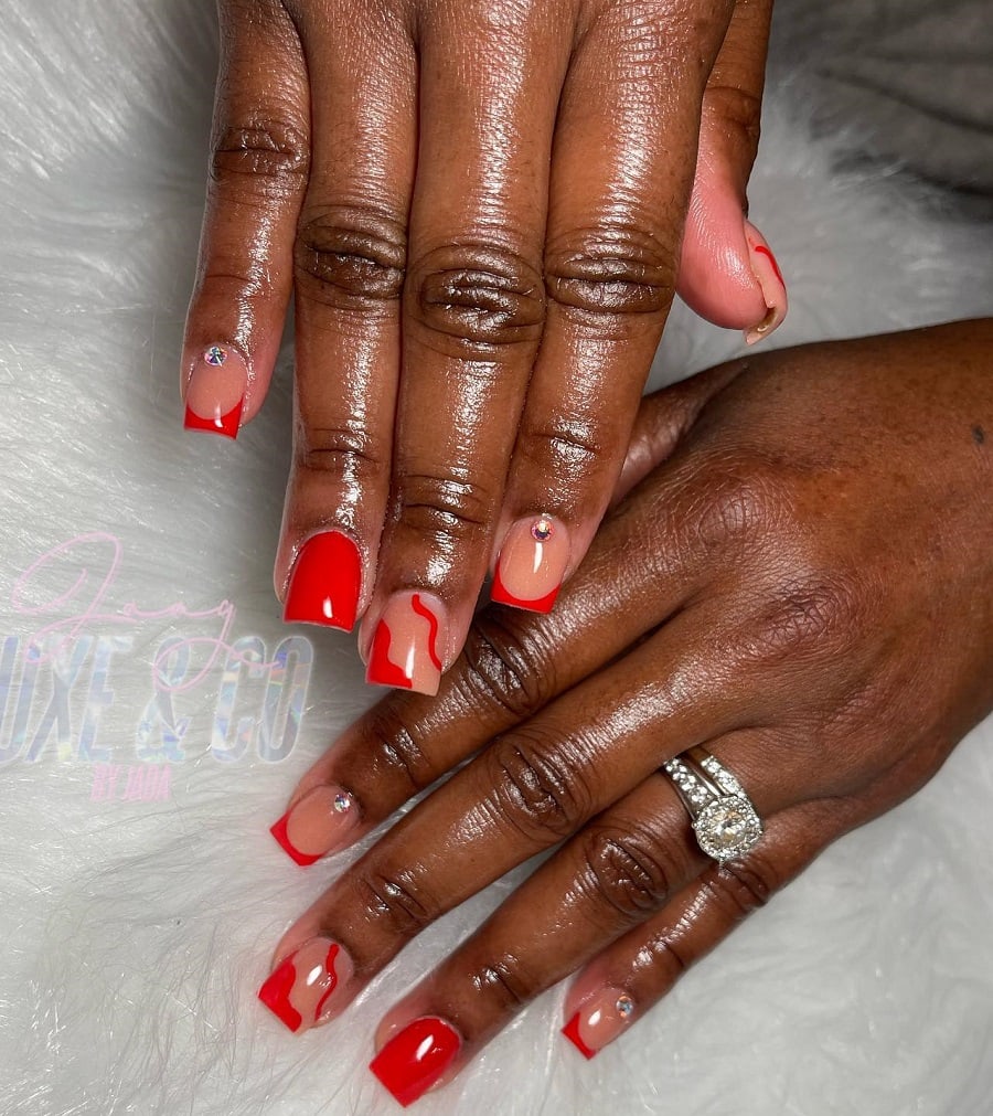 red and nude nails on dark skin