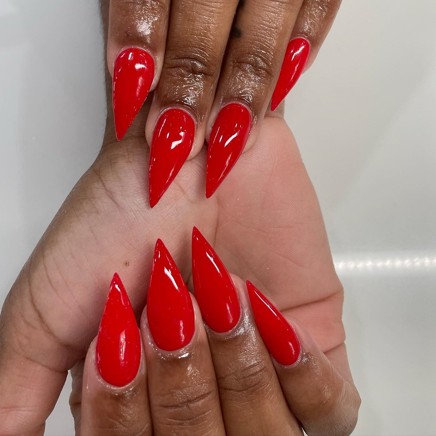 red stiletto nails on dark skin