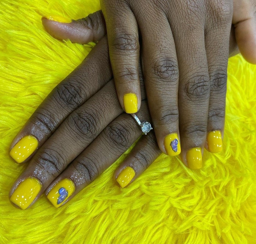 yellow nail art on dark skin